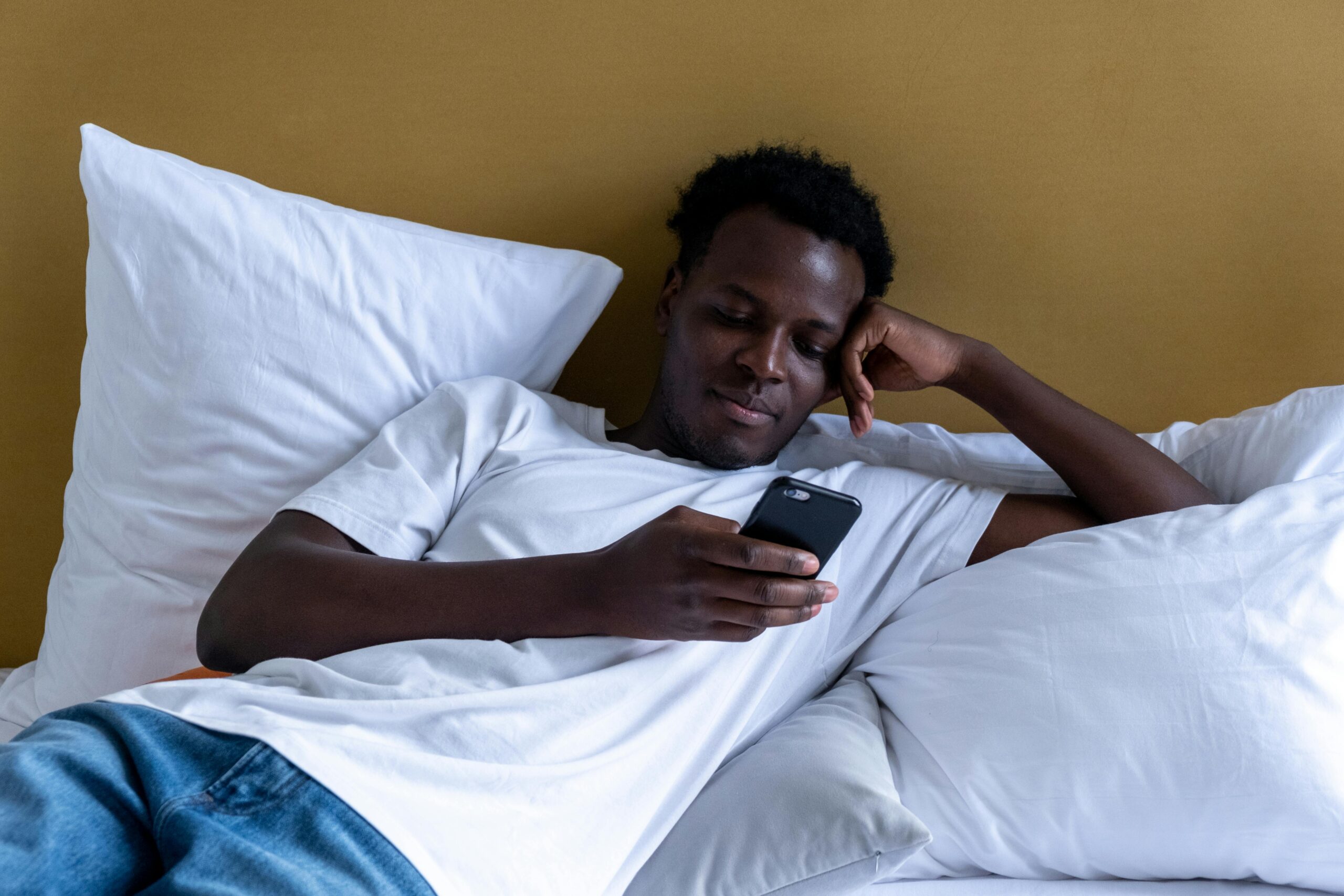 image of person in bed phone scrolling